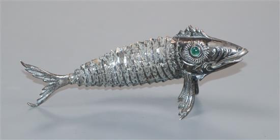 A Spanish white metal articulated model of a fish with green cabochon eyes, 12.4cm.